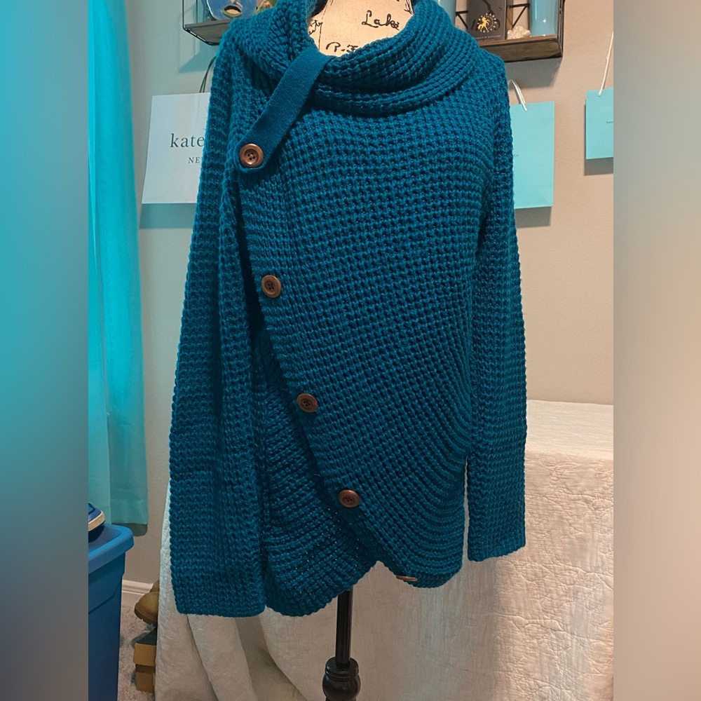 Teal sweater. Asymmetrical Neckline with button details.